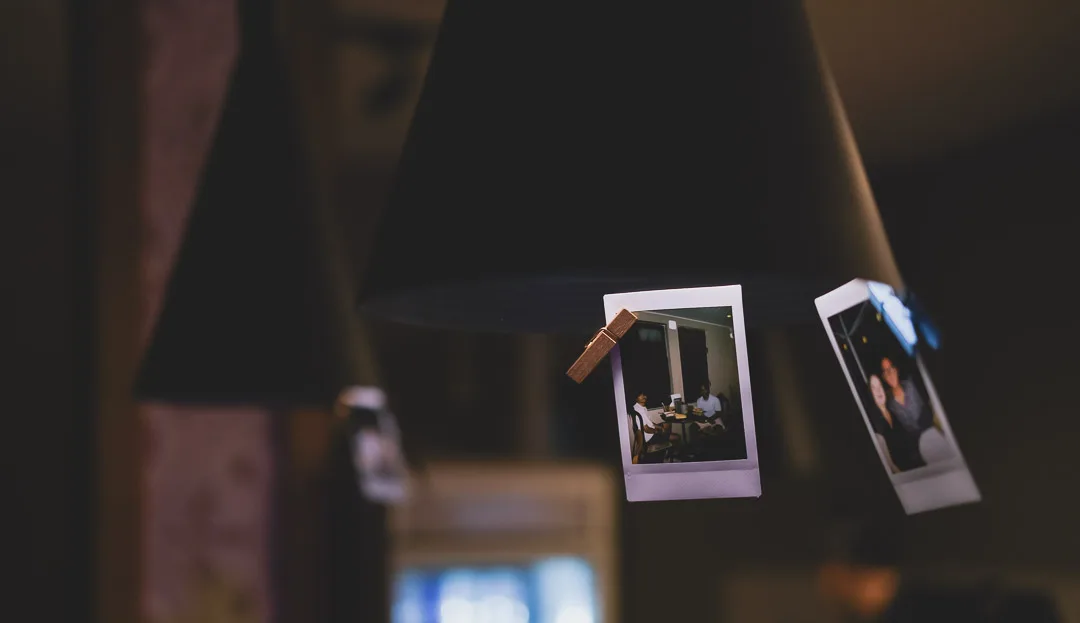 Polaroid photographs of guests pegged up above the bar